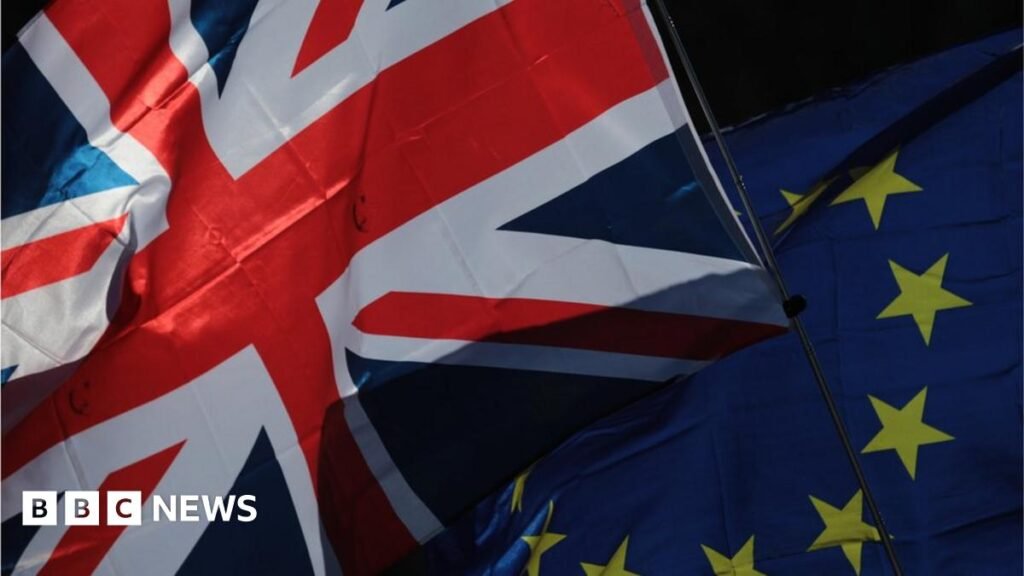 A Union flag, also known as Union Jack, left, and a European Union (EU) flag fly during a Unite for Europe march to protest Brexit in central London, U.K.