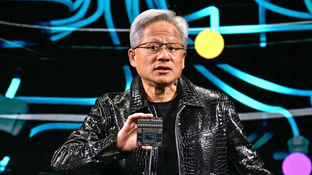 Nvidia CEO Jensen Huang holds a Nvidia's Drive Thor processor as he delivers a keynote address at the Consumer Electronics Show in Las Vegas.