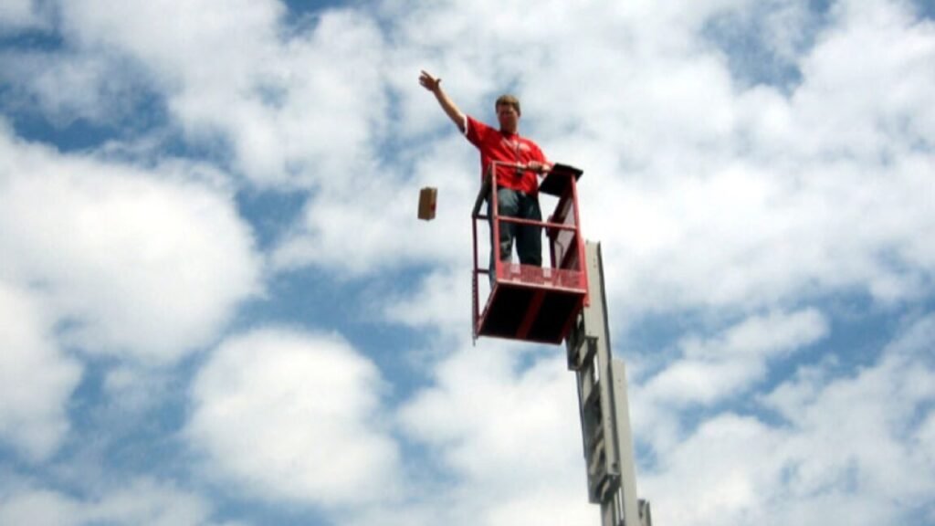 A physics teacher on a lift drops a package designed to protect three eggs from a fall of ten meters