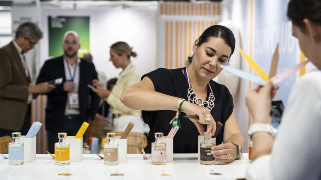 Perfume stall customers smelling samples.