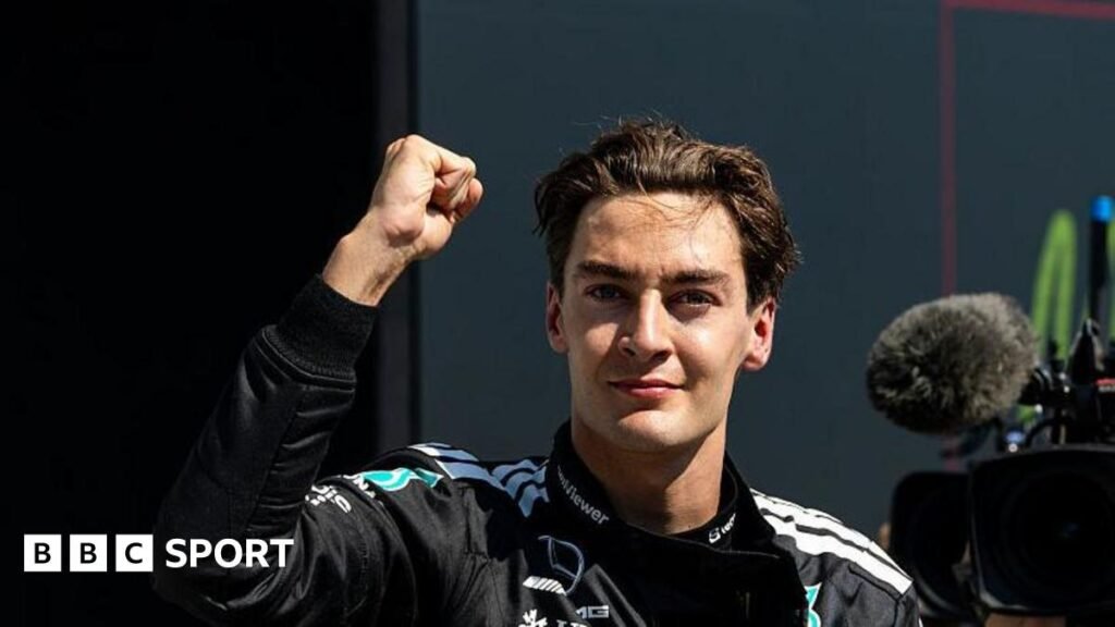 George Russell throwing a fist in the air to celebrate winning the Canadian Grand Prix