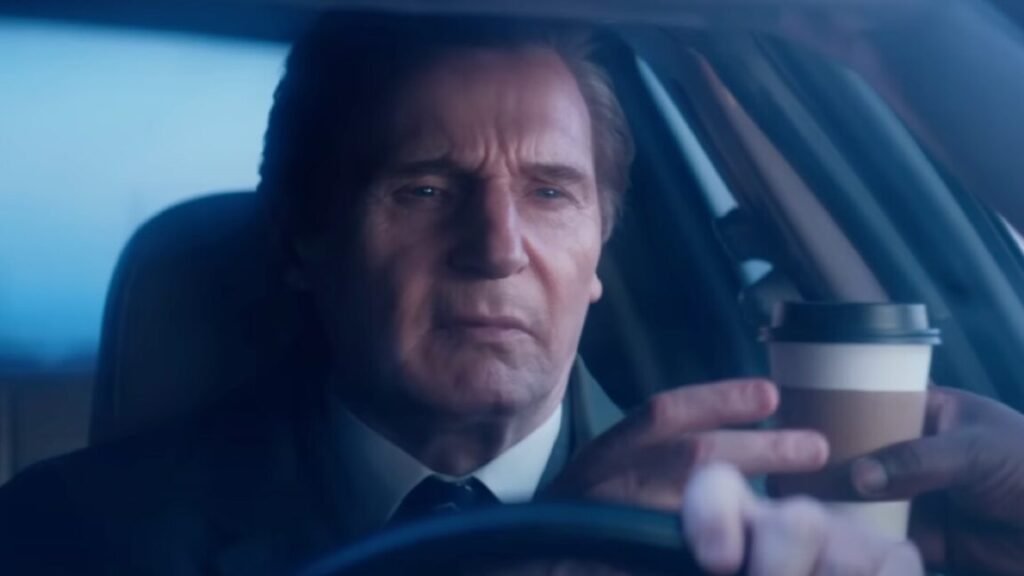 close up middle aged man in a suit with a hand handing him a coffee cup through the driver's side window