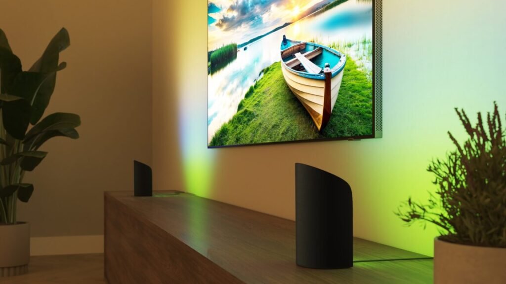 Two Philips Hue Play devices facing a wall that has a TV mounted to it.
