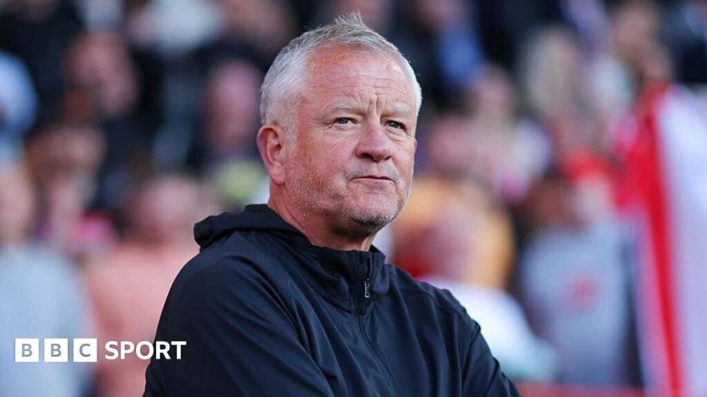 Pep Guardiola looks at Erling Haaland