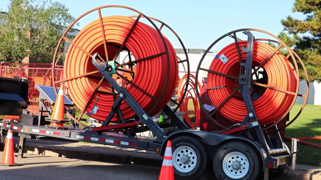 Two large spools of fiber conduits, which are used to install fiber cables underground.