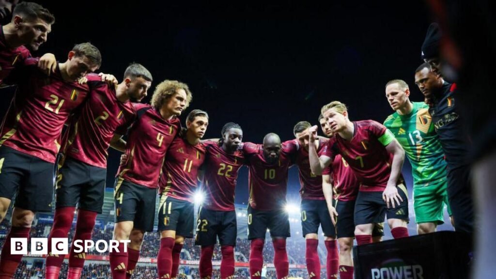 Kevin de Bruyne gives a team talk in a huddle of Belgium players