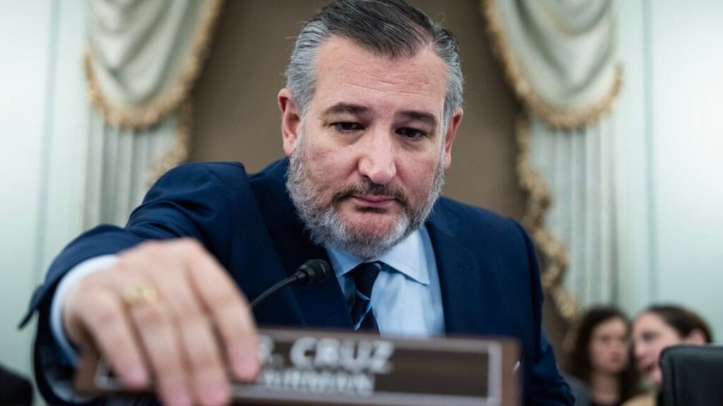 A huge fight looms over the NASA budget this fall Senator Ted Cruz at a Senate committee hearing, sitting in his seat and using his hand to move a nameplate that says "Mr. Cruz, Chairman."