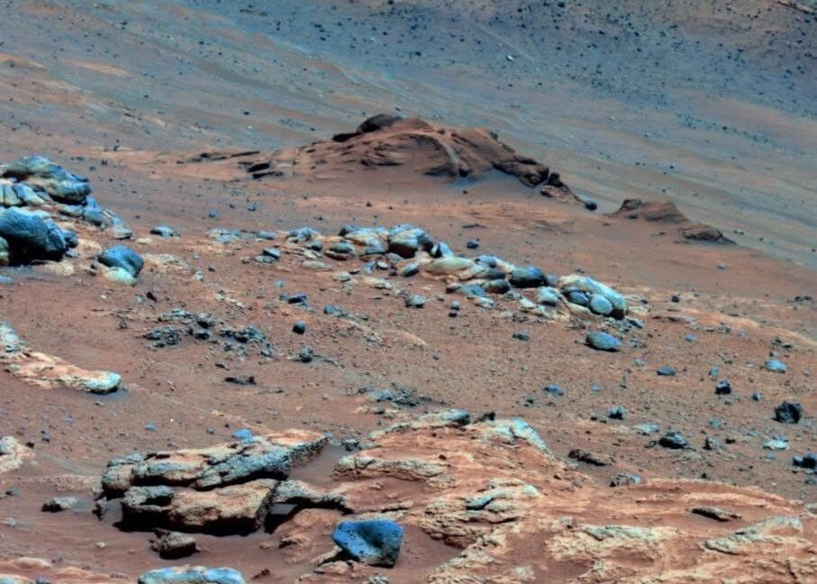 A new Martian climate model suggest a mostly cold, harsh environment Image of a mix of rocks and dust, with the dust having a strong reddish tint.