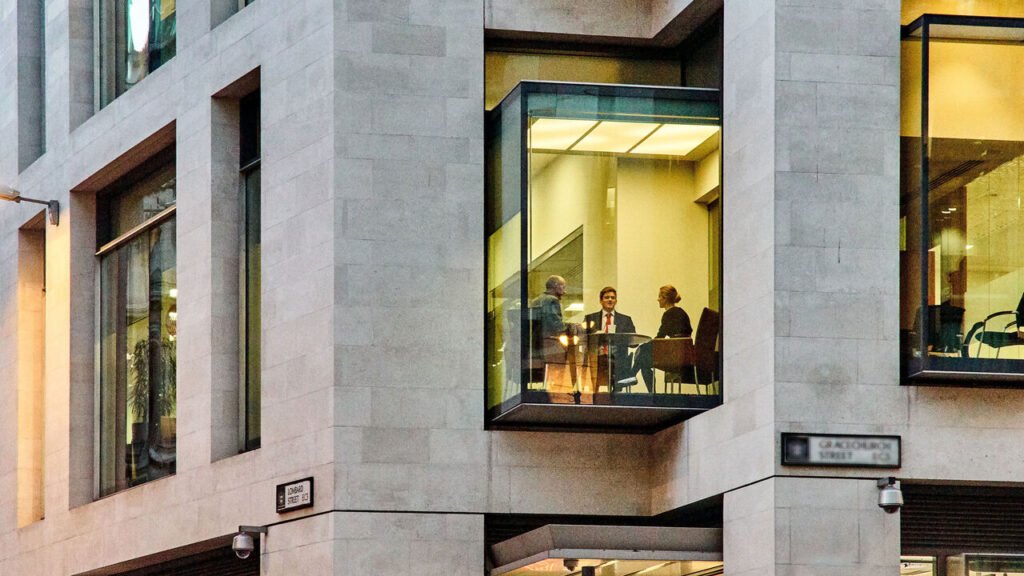 An office worker looking at a big wall made of Lego bricks, in the shape of a heart.