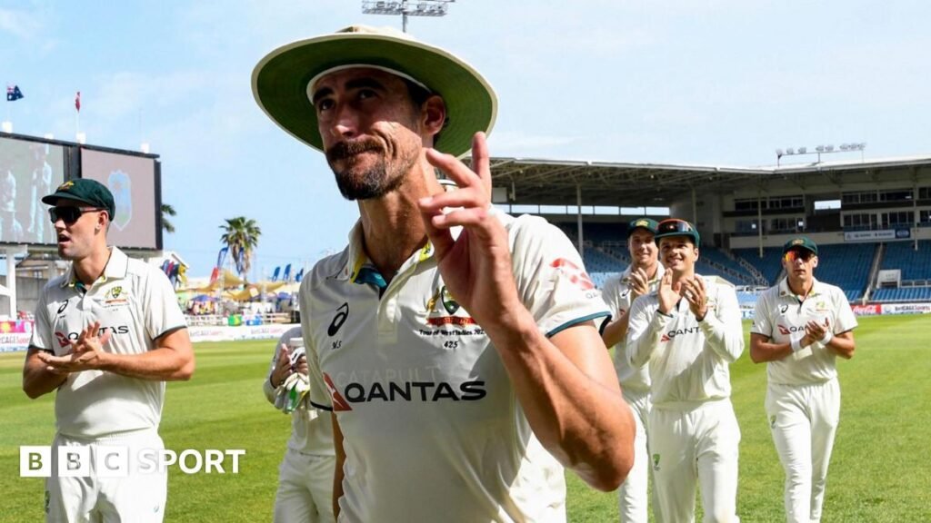 Australia quick bowler Mitchell Starc waves as he walks off, applauded by his team-mates
