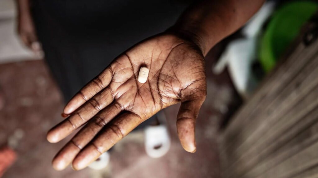Picture of an ARV tablet in someone's hand