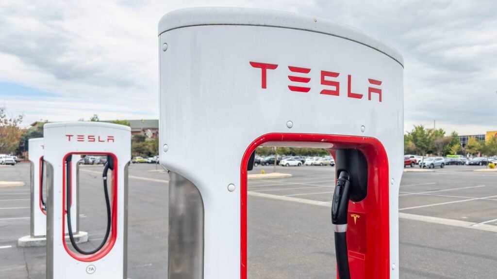 A red and white Tesla Supercharger for charging electric vehicles