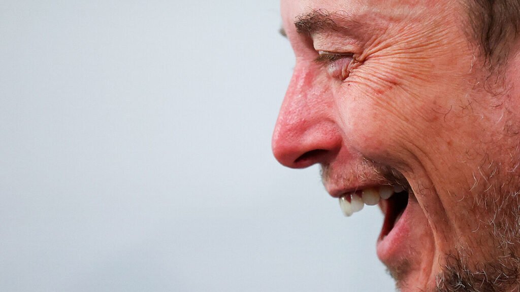 Elon Musk laughing.